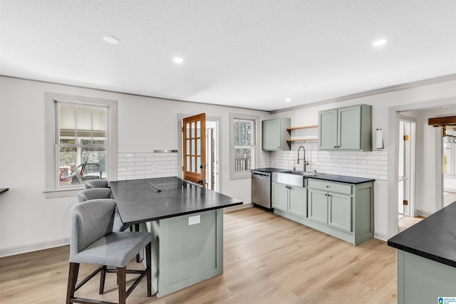 kitchen featuring black electric cooktop, sink, dishwasher, and light wood-type flooring