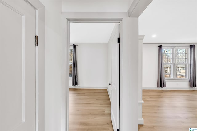 hallway with light hardwood / wood-style flooring