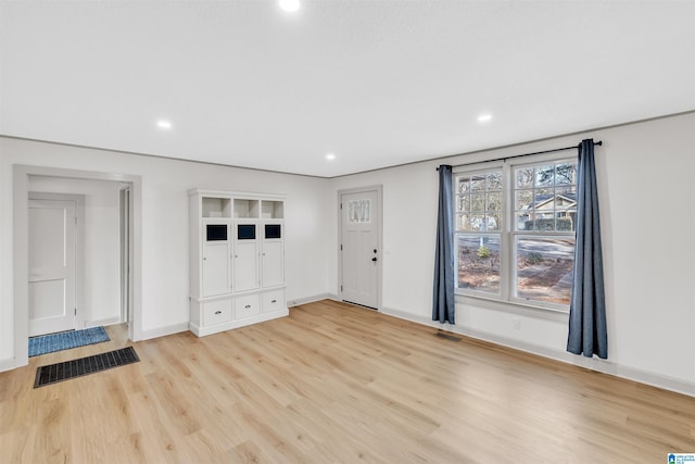 unfurnished living room featuring light hardwood / wood-style floors