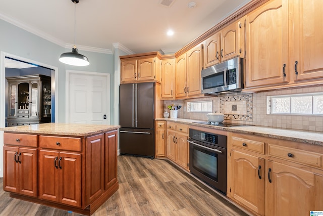 kitchen with crown molding, tasteful backsplash, wood-type flooring, a center island, and black appliances