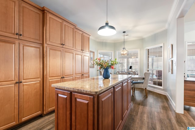 kitchen featuring light stone counters, a center island, dark wood-type flooring, and hanging light fixtures