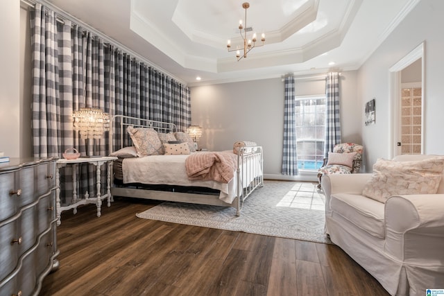 bedroom featuring crown molding, hardwood / wood-style floors, a notable chandelier, and a tray ceiling