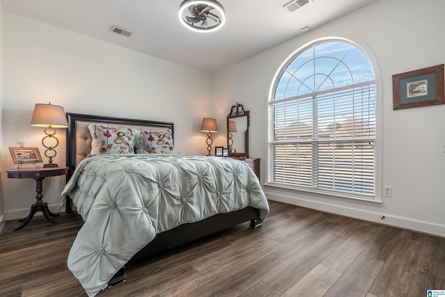 bedroom with dark wood-type flooring