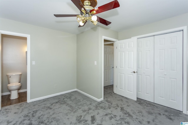 unfurnished bedroom with baseboards, ensuite bath, ceiling fan, a closet, and carpet flooring