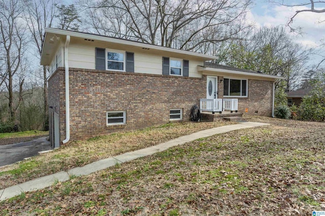 tri-level home featuring brick siding