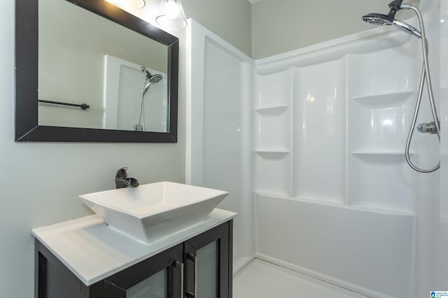 bathroom with vanity and a shower