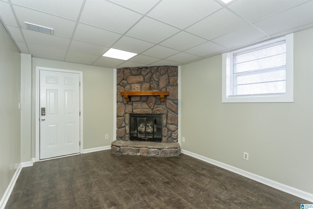 unfurnished living room featuring wood finished floors, a fireplace, visible vents, and a paneled ceiling