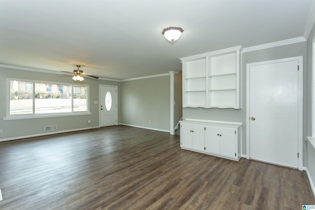 unfurnished living room featuring crown molding, dark wood-style floors, visible vents, and baseboards