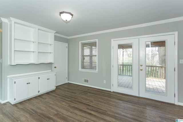 unfurnished dining area with dark wood finished floors, crown molding, french doors, and visible vents