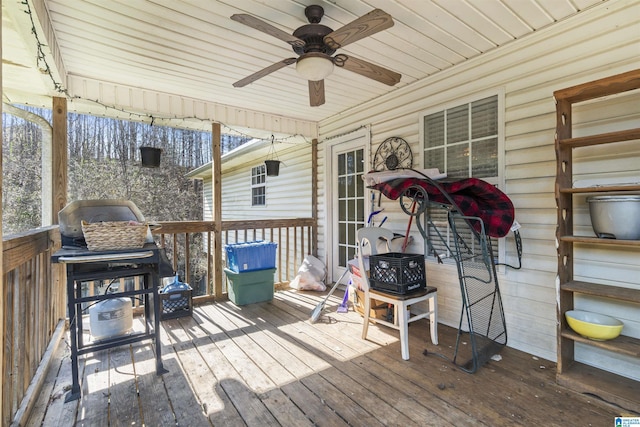 deck with grilling area and ceiling fan