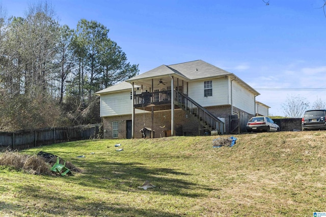 rear view of house with a yard, ceiling fan, and a deck