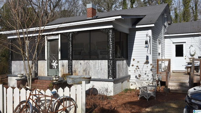 view of property exterior featuring a sunroom