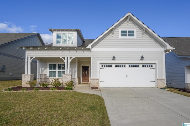 view of front facade with a porch, a garage, and a front yard