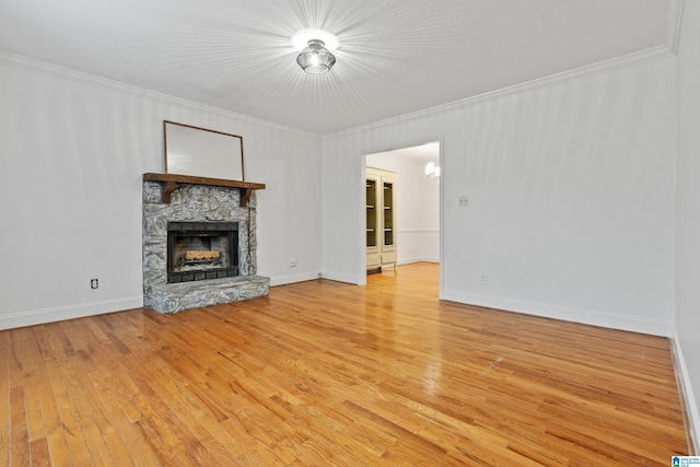 unfurnished living room with crown molding, a fireplace, and hardwood / wood-style floors