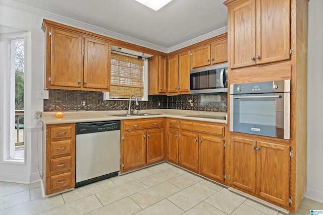 kitchen with sink, decorative backsplash, plenty of natural light, and appliances with stainless steel finishes