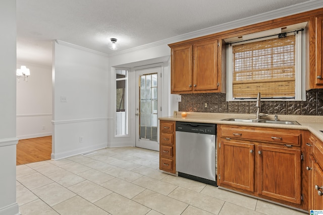 kitchen featuring light tile patterned flooring, sink, crown molding, tasteful backsplash, and dishwasher