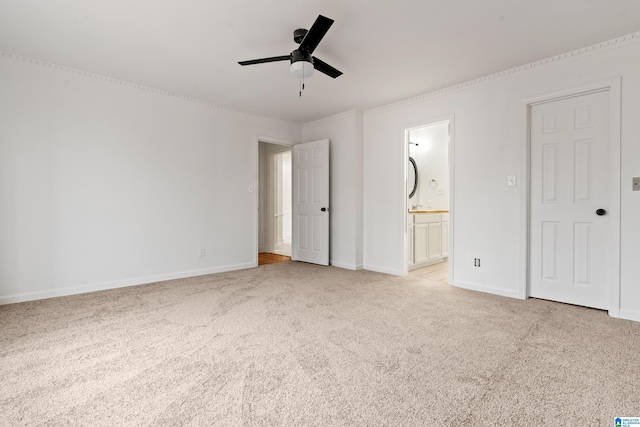 unfurnished bedroom featuring ceiling fan, ornamental molding, light colored carpet, and ensuite bath