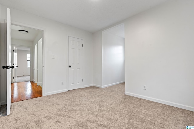 unfurnished bedroom with light carpet