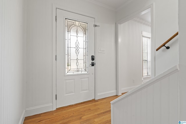 entrance foyer featuring crown molding and hardwood / wood-style flooring