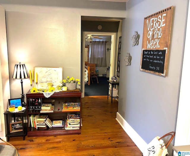 corridor with hardwood / wood-style floors