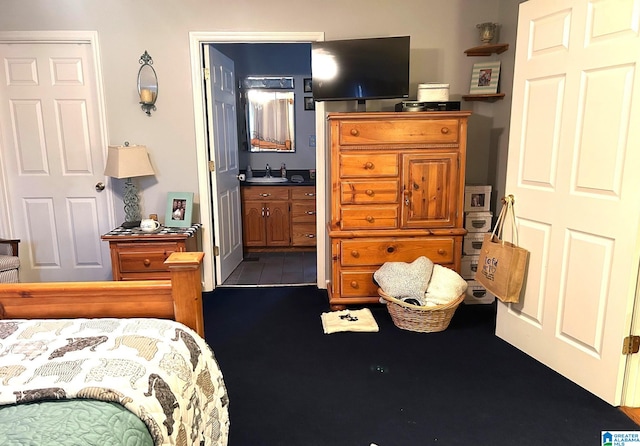 bedroom featuring sink and ensuite bathroom