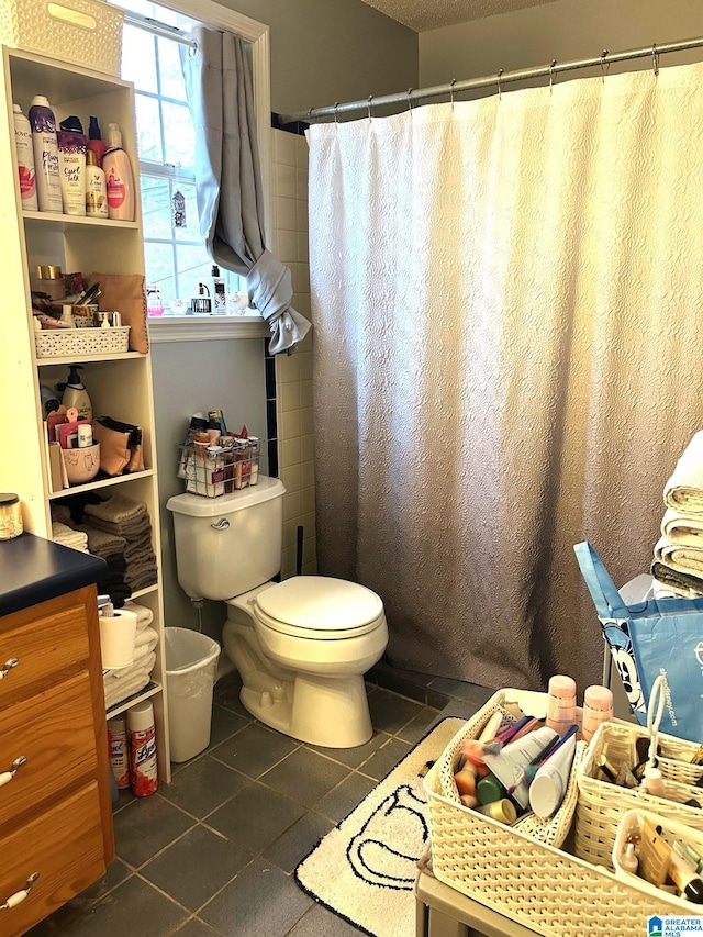 bathroom featuring tile patterned flooring and toilet