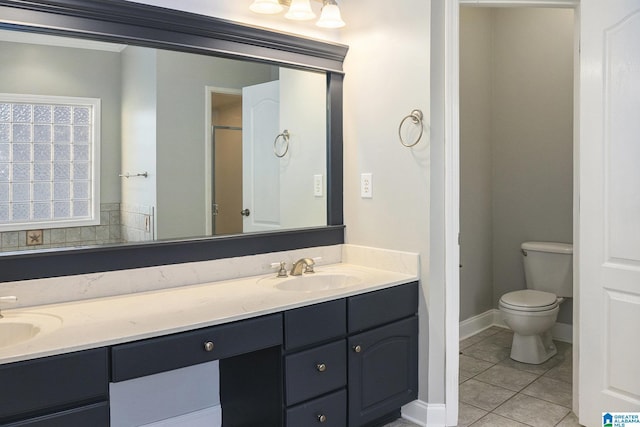 bathroom with vanity, toilet, and tile patterned flooring