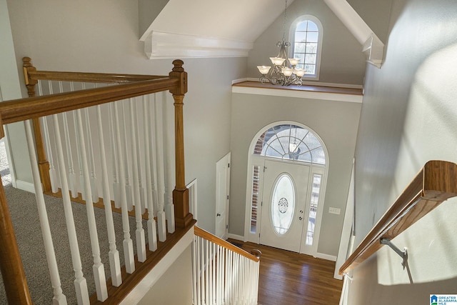 foyer with dark hardwood / wood-style floors, a chandelier, and high vaulted ceiling