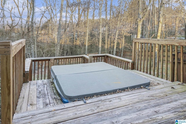 wooden deck featuring a covered hot tub