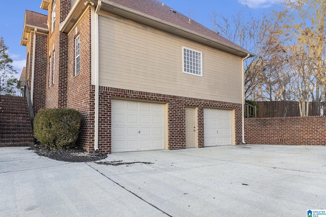 view of side of home featuring a garage