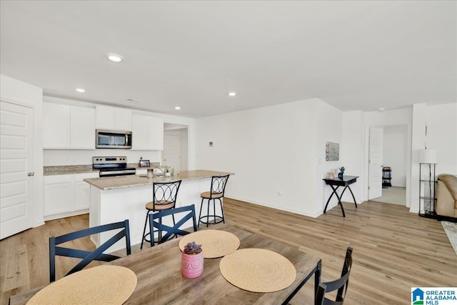 dining space featuring light hardwood / wood-style floors