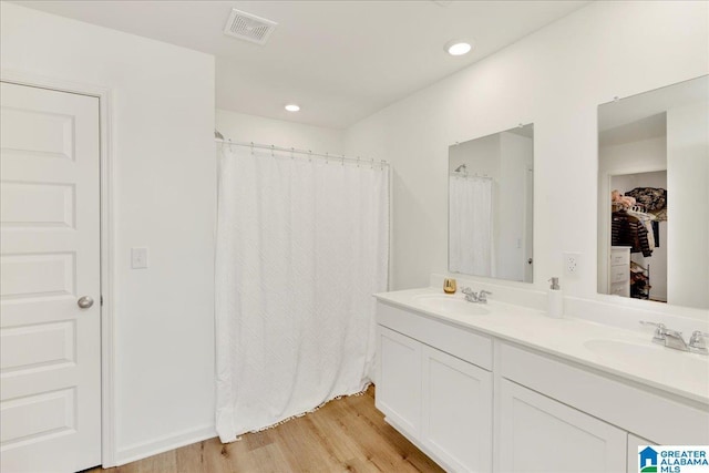 bathroom with hardwood / wood-style flooring and vanity