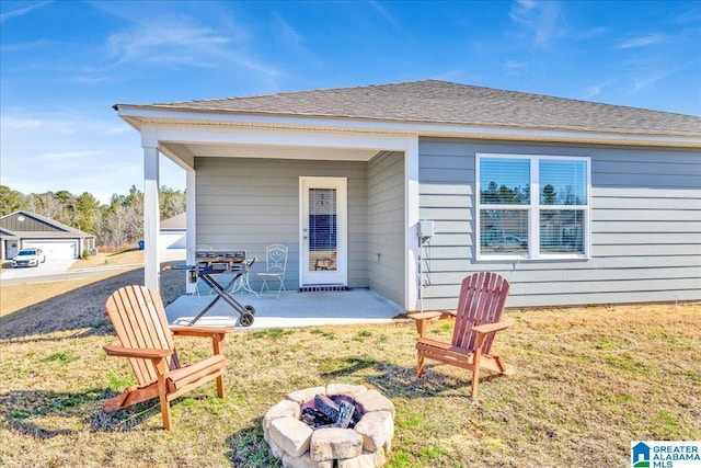 back of property featuring a patio and an outdoor fire pit