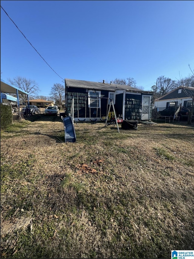 rear view of property with a yard