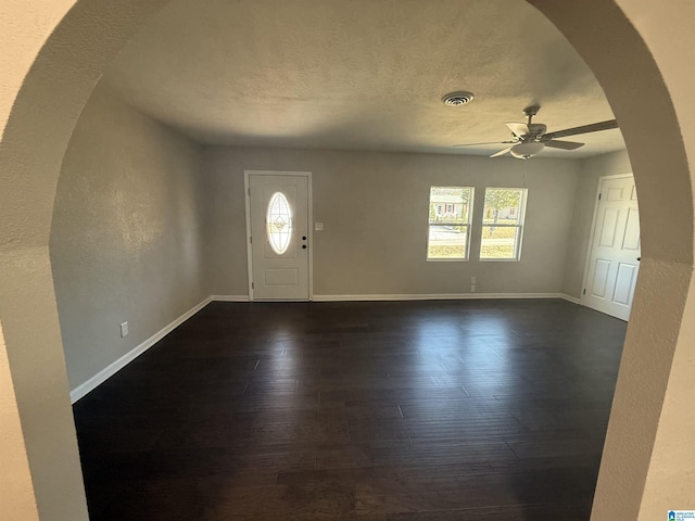 entrance foyer featuring dark hardwood / wood-style floors, a textured ceiling, and ceiling fan