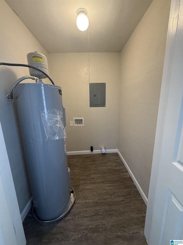 laundry area featuring dark wood-type flooring, water heater, electric panel, washer hookup, and a textured ceiling