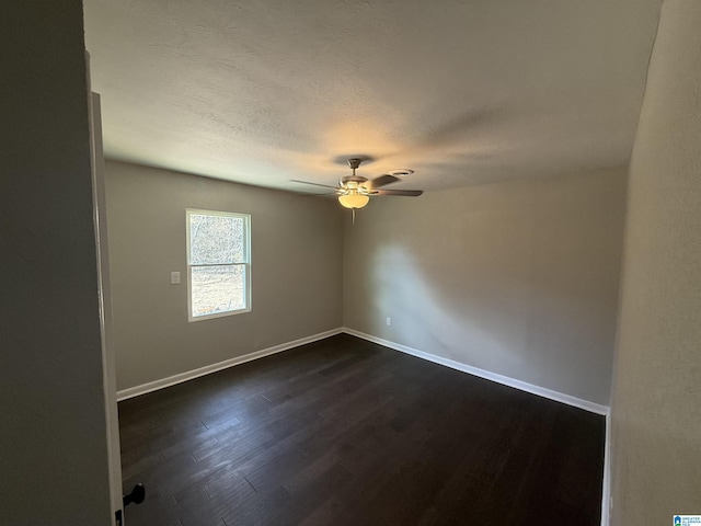 spare room featuring a textured ceiling, dark hardwood / wood-style floors, and ceiling fan