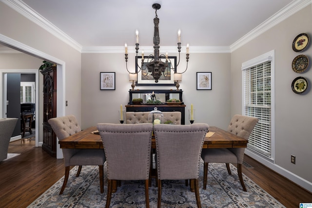 dining area with dark hardwood / wood-style flooring, crown molding, and a chandelier