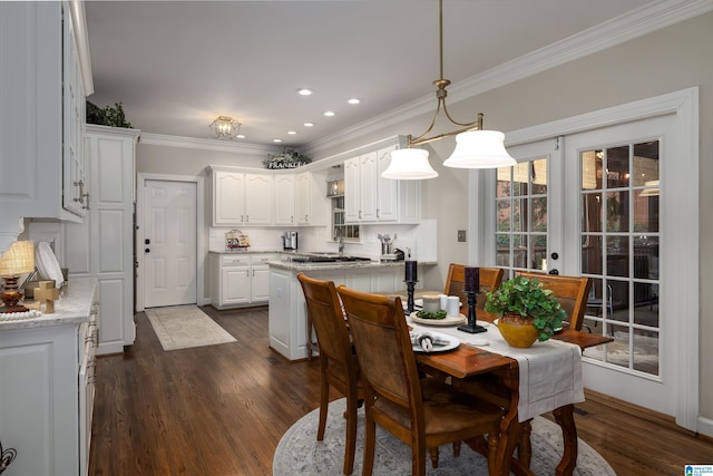 dining space with ornamental molding, dark hardwood / wood-style floors, and french doors