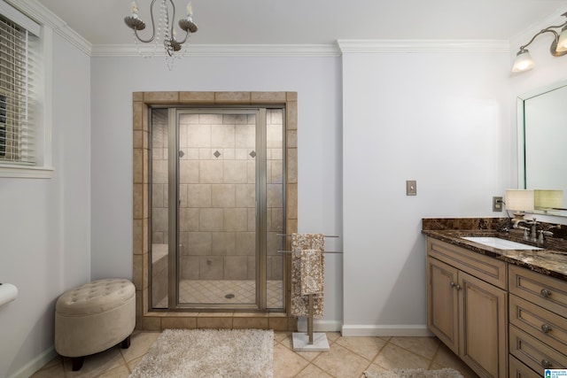 bathroom with crown molding, vanity, an inviting chandelier, and a shower with door