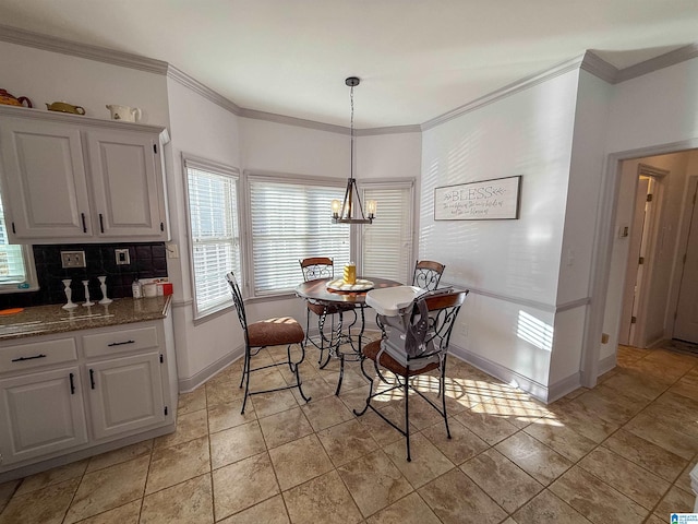 dining space with ornamental molding and a notable chandelier