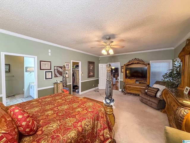 carpeted bedroom with crown molding, a walk in closet, and a textured ceiling