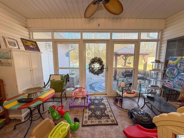 sunroom / solarium with wooden ceiling and ceiling fan