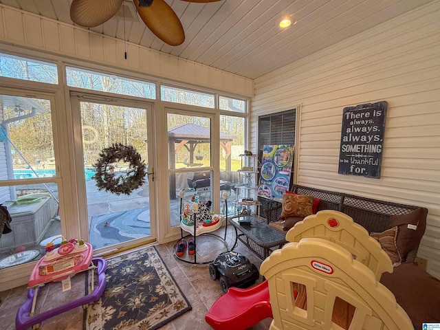 sunroom / solarium featuring wood ceiling and ceiling fan