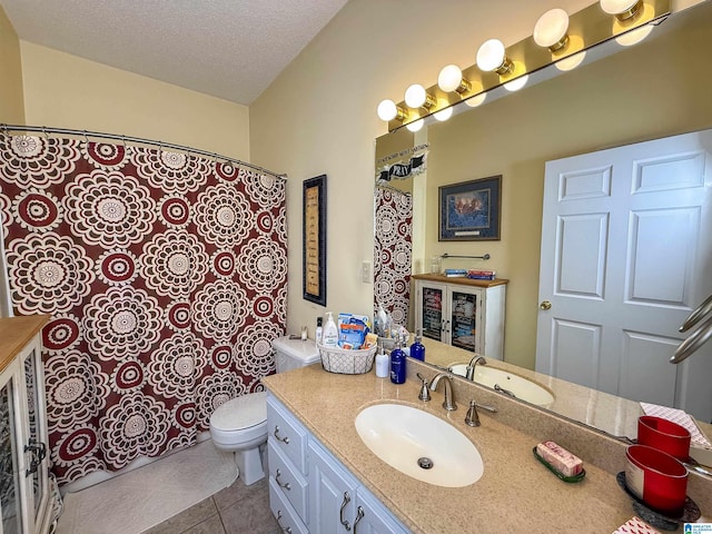 bathroom with vanity, tile patterned floors, a textured ceiling, and toilet