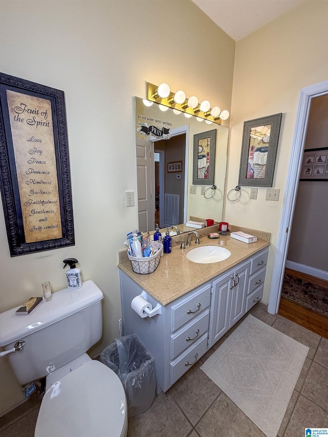 bathroom featuring tile patterned flooring, vanity, and toilet