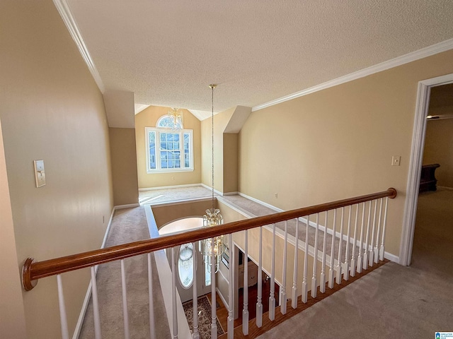 stairway with ornamental molding, carpet, a notable chandelier, and a textured ceiling