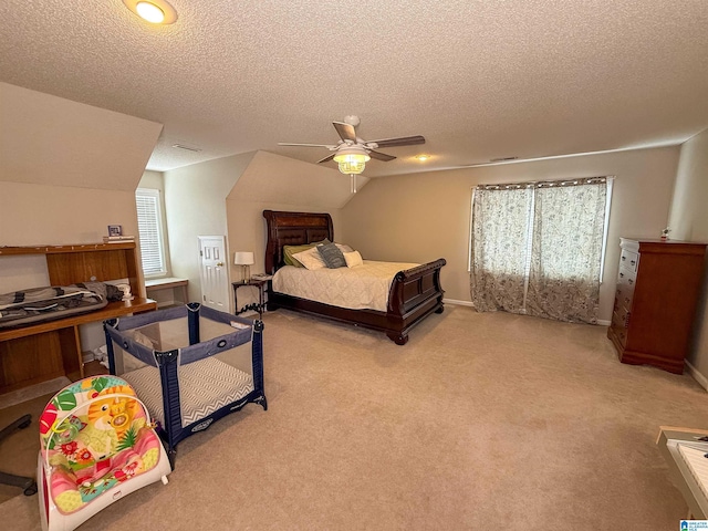 carpeted bedroom featuring a textured ceiling, vaulted ceiling, and ceiling fan