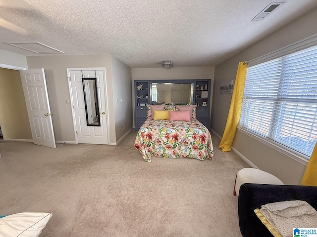 carpeted bedroom with a textured ceiling