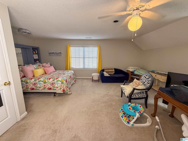 carpeted bedroom with ceiling fan, lofted ceiling, and a textured ceiling